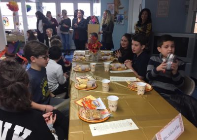 The full group of students, teachers, parents, and more putting together one of the best thanksgiving feasts we've had the pleasure of being a part of!