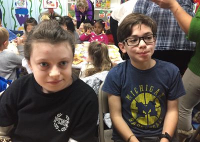 Two friends hanging out at the West Hills Academy Thanksgiving Feast!